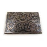 A white metal and niello enamel box, the lid with scrolling floral decoration, the base engraved