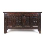 A late 17th century and later oak coffer, the two panel top with carved diamonds opening to reveal a