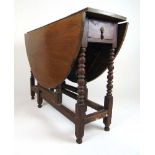 A late 17th century and later oak drop leaf table, the oval top supported on a single gate action