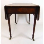 An early 19th century mahogany and ebony strung Pembroke table, the drop leaf top over single end