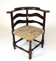 A late George III provincial elm corner chair, with wavy splat bands united by plain turned