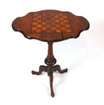 A victorian walnut veneered games table, with inlaid parquetry chess board top with swivel action