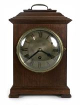 A George III style bracket clock timepiece, the silvered dial with Roman numerals on a single