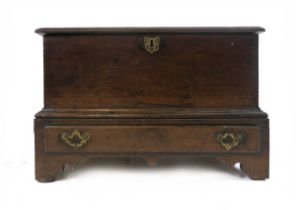 An 18th century oak coffer bach, the base with moulded edge above a single drawer, on bracket