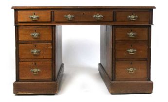 A late Victorian/early Edwardian two pedestal desk, having three drawers to top and three drawers to