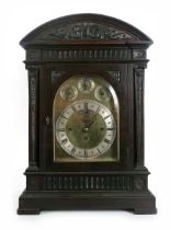 A large early 20th centiry mahogany cased bracket clock, the arch brass dial with silvered chapter