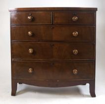 A 19thcentury mahogany bow fronted chest of drawers, the turned handles inset with mother of