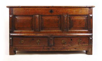 An early 18th century oak mule chest, the top lifting to reveal a vacant interior over the three
