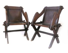 A pair of late 19th century pitch pine Glastonbury chairs, approximately 67cm wide, 86.5cm high