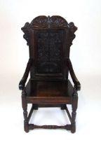 A 17th century and later joined oak armchair, possibly Yorkshire/Leeds, with foliate scroll top rail