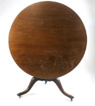 A George III mahogany tilt top table, with large circular top on a vase shape suport with three