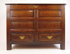 An early 18th century oak mule chest, the top lifting to reveal a vacant interior over the four
