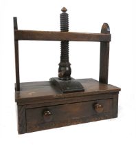 A 19th century elm book/linen press, the thread screw with a pointed finial, above a single drawer