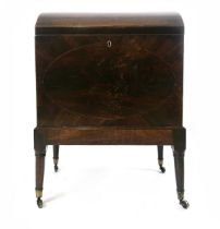 A Regency mahogany dome topped cellarette, with strung edges and oval front panel, on slightly