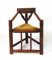 A Victorian carved oak turners chair, with chip carved top rail and buttress supports, and with ring