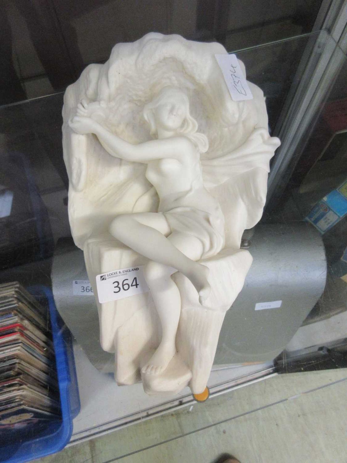 A plaster moulded wall sconce in the form of a scantily clad lady