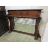 An early 20th century walnut over mantle mirror with Corinthian columned supports