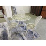 A cast aluminium white painted garden table and three chairs