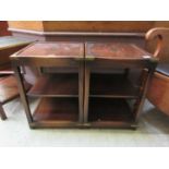 A pair of reproduction mahogany and brass mounted lamp tables with pull-out slides to side