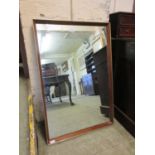 A mahogany framed rectangular mirror with brass edgingGilt fading to edges of mirror in places. Some