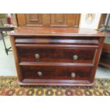 A 19th century mahogany chest of three long drawers with lion mask handles
