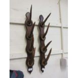 A pair of early 20th century antler hooks on mounts