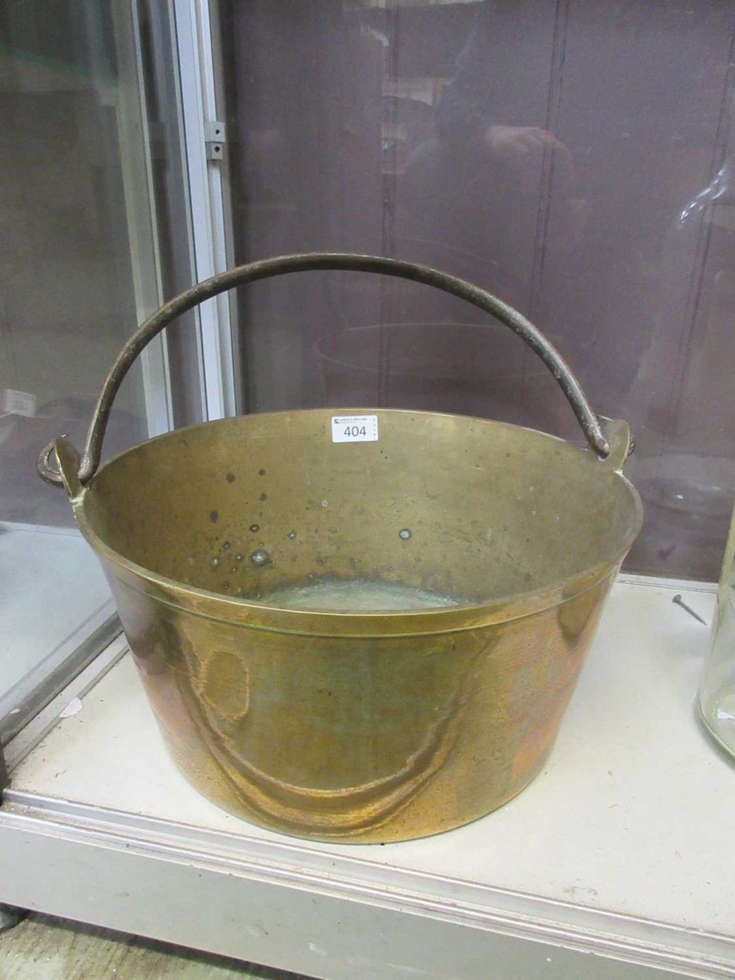 A brass jam pan