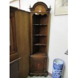 A reproduction mahogany and marquetry floor standing corner cupboard