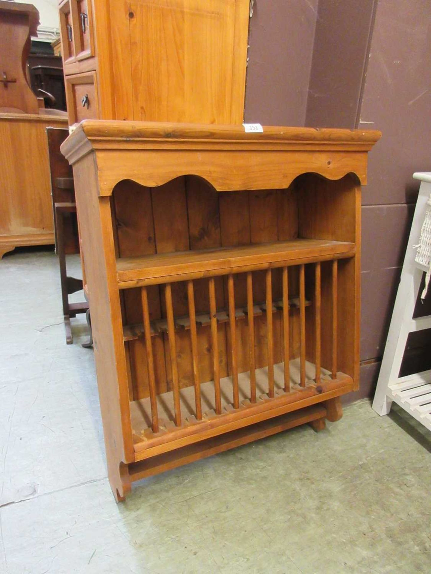 A waxed pine wall mounted plate rack