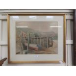 A framed and glazed watercolour of boat on beach scene