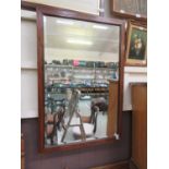 A rosewood and boxwood strung bevel glass mirror