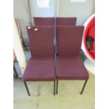 A set of four burgundy upholstered metal framed office chairs