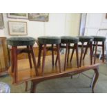 Five early 20th century bar stools with green upholstered seats