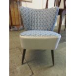 A newly reupholstered mid-20th century nursing chair upholstered in a blue fabric