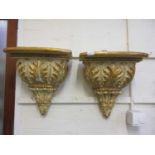 A pair of modern parcel gilt and cream wall brackets