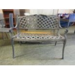 A modern cast aluminium garden bench