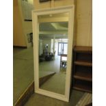 A large white framed rectangular mirror