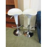 A pair of adjustable stools, white seat on chrome base