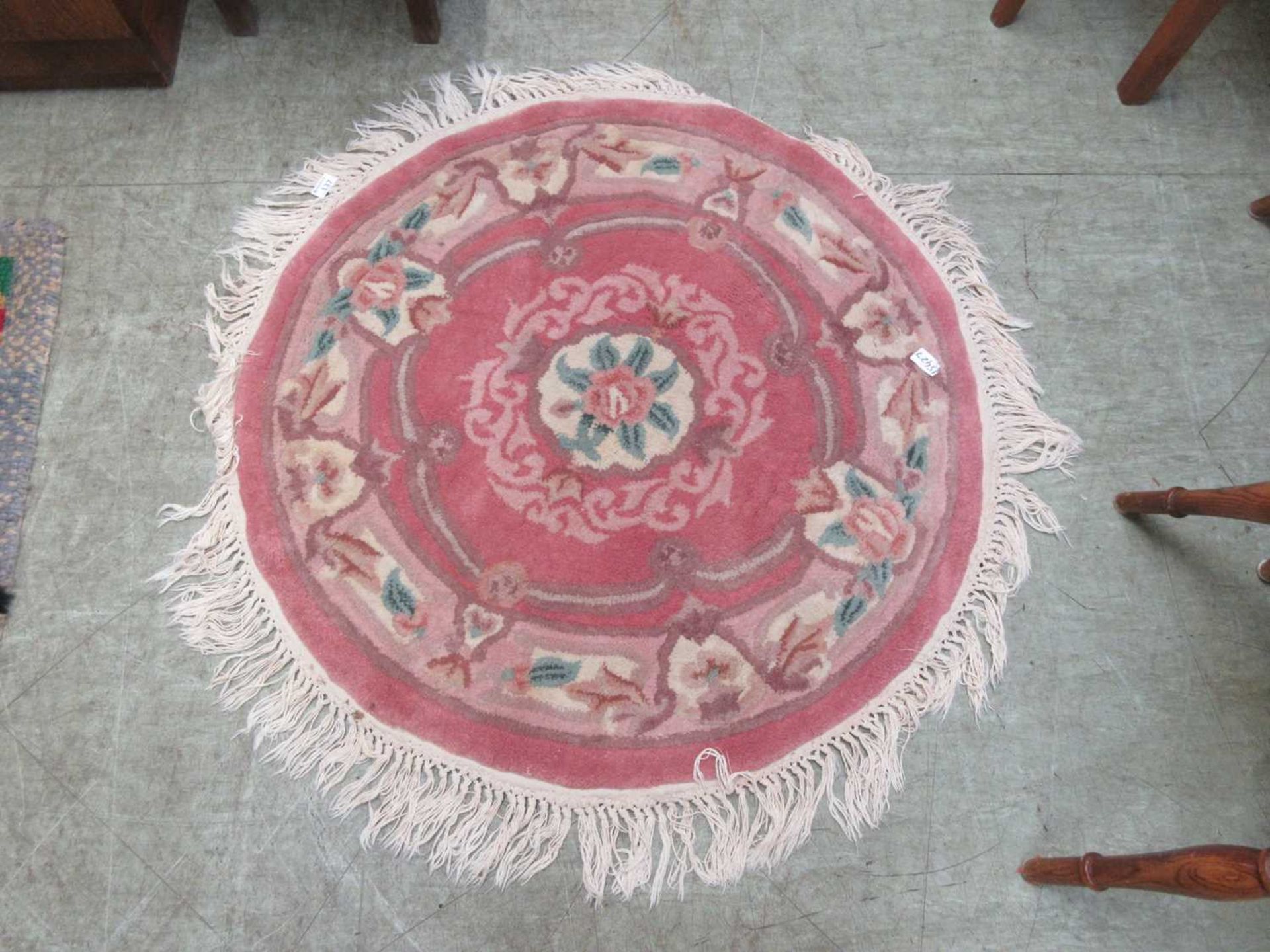 A circular pink ground Chinese style rug