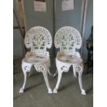 A pair of white painted cast aluminium garden chairs