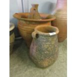 A terracotta garden pot, terracotta urn, and a terracotta jug