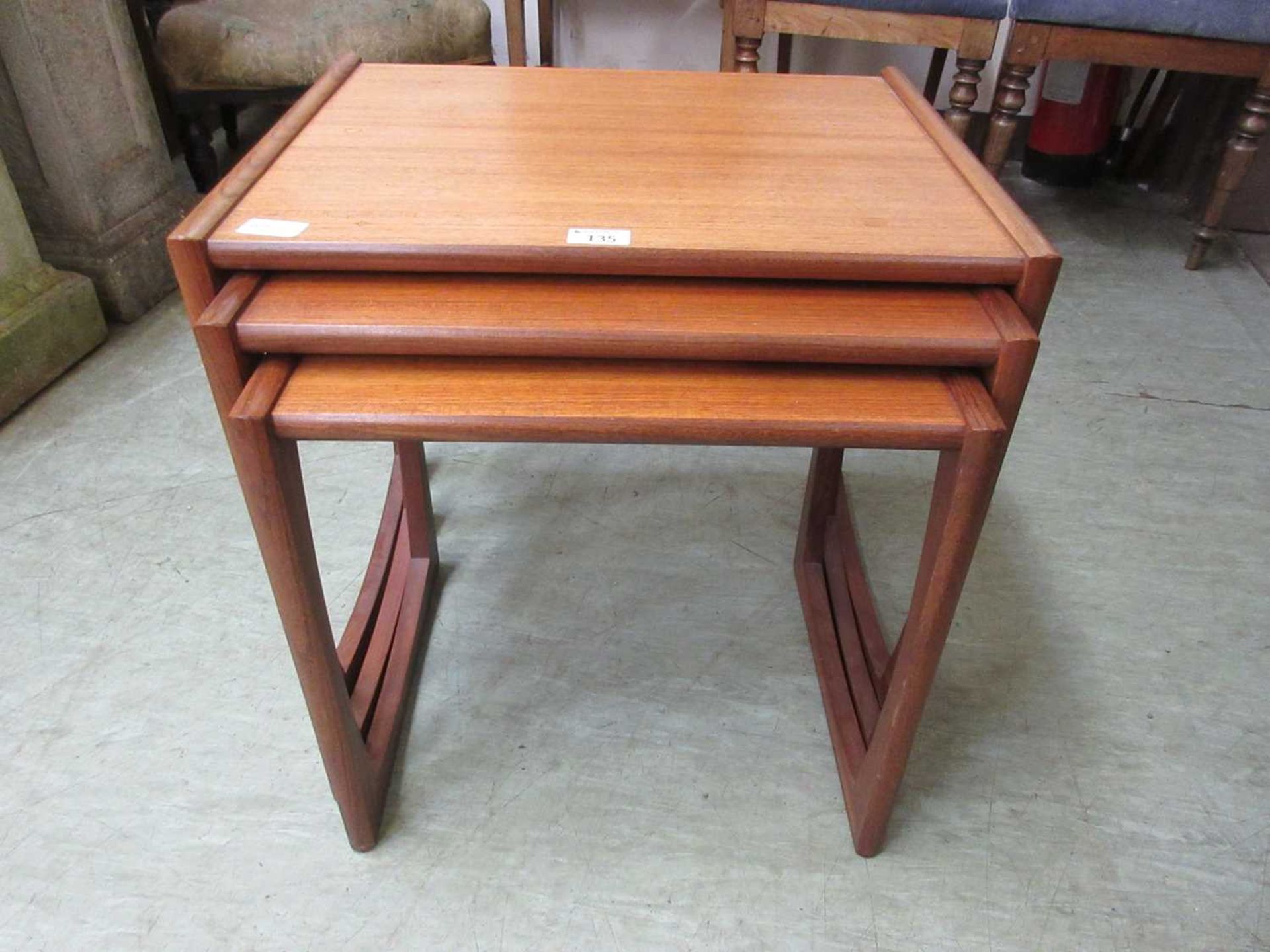 A nest of three mid-20th century teak occasional tables