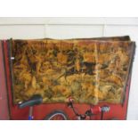 A wall hanging tapestry depicting huntsmen fighting lions