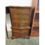 A reproduction mahogany serpentine fronted miniature chest on chest