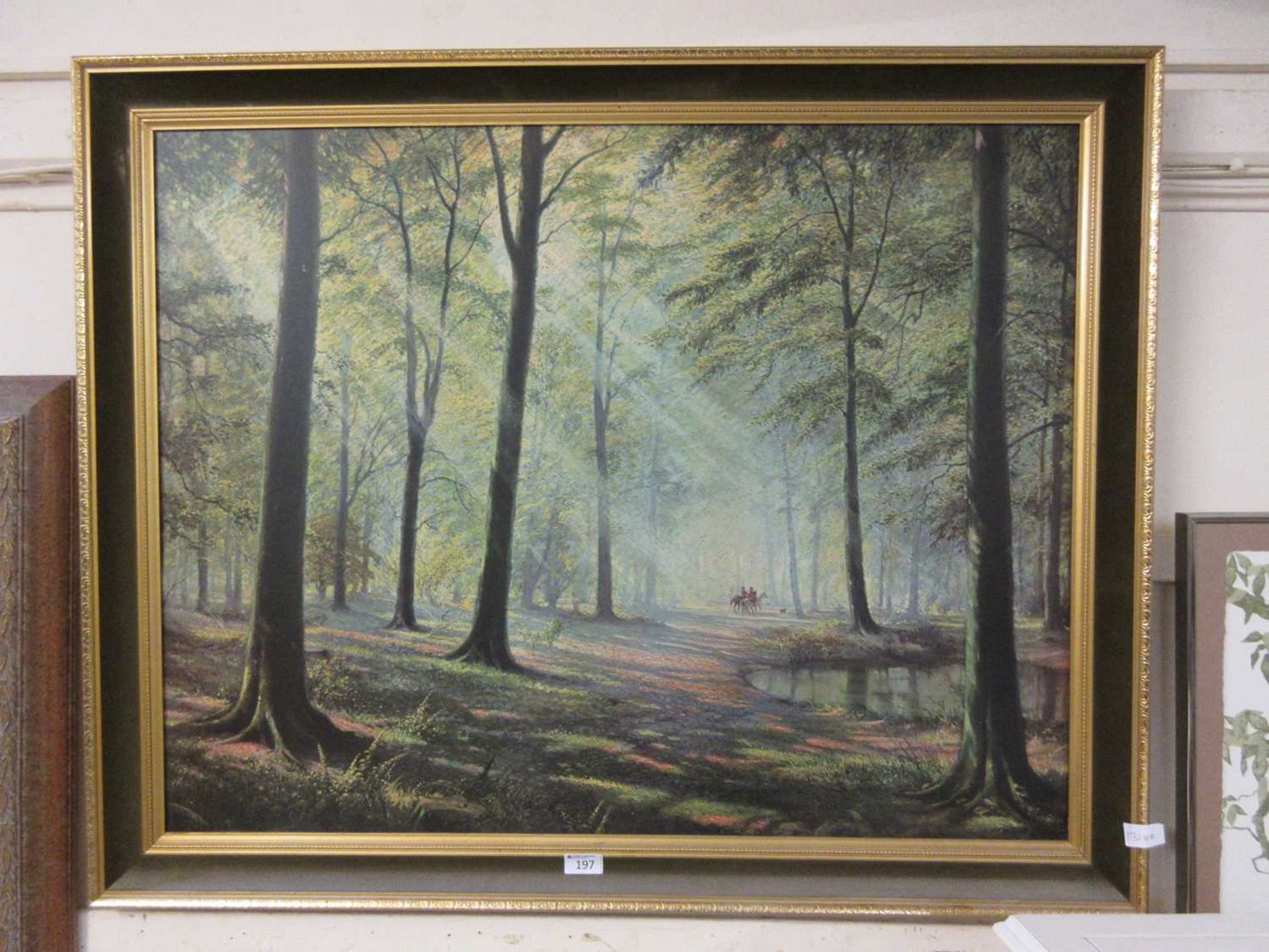 A large gilt framed print of horsemen in woods