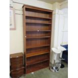 A teak open bookcase with adjustable shelves