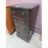 A stained wooden chest of four drawers