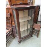 A mid-20th century mahogany veneered glazed display cabinet on ball and claw feet (A/F)