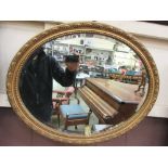 An oval gilt framed bevel glass mirror