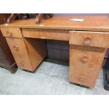 A mid-20th century oak twin pedestal desk